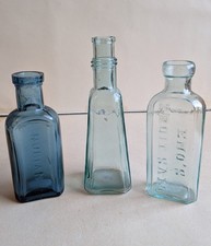 3 Vintage Bottles with Embossed Writing Marks On Them.