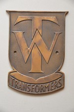 Vintage brass machine plate TW (or WT) Transformers in shield shape