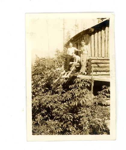 Shirtless men log - , cabin