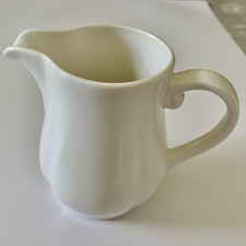Pre-own  Dudson 1  milk jug with scalloped edges .