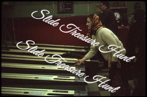Woman playing skee ball - woman,