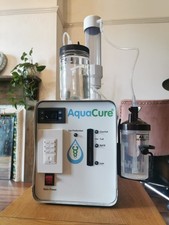AquaCure benchtop gas generator – white/grey unit with front gauge, on/off switc