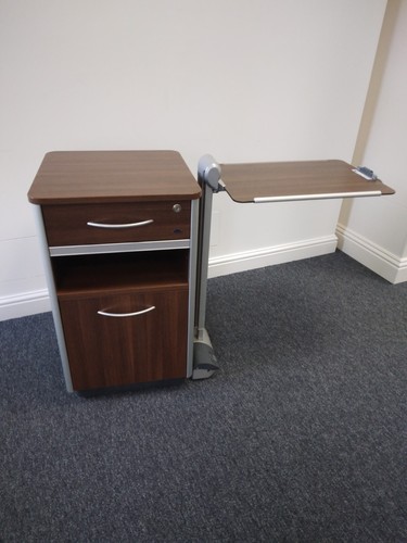 Dark wood cabinet with - , overbed