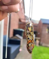 This is a beautiful pallasite meteorite necklace from space!