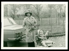 Woman with pram next to