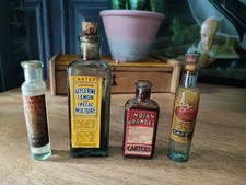 FOUR EARLY TO MID CENTURY LABELLED CHEMIST BOTTLES, SOME WITH CONTENTS
