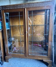 Wooden (oak?) Display cabinet with carved detail and leaded glass doors