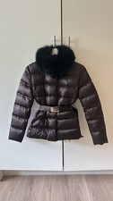 Prada Brown  down puffer jacket with a fox fur collar and a belted waist.