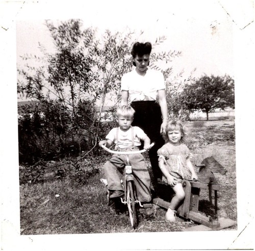 Stern mother with tricycle boy - stern,