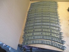 Hornby Dublo. 16 curved 3-rail track. One with terminal, used, worn. Clean backs