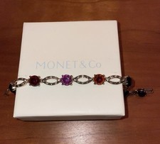 Monet gold coloured bracelet with coloured stones and decorative links. 7 1/4"