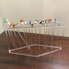 A Set If Sixteen Murano Swizzle Sticks With Stand