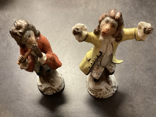 Two figures seated village - figures,