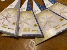 4 x LED Christmas Star Lanterns glossy paper. Folded in boxes Batteries optional