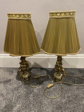 Pair Of Antique Gold Coloured Cherub Lamps With Green Pleated Lamp Shades