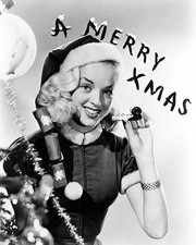 Diana Dors poses in a Santa