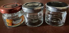 THREE SMALL EMPTY JAM JARS