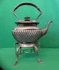 antique pewter teapot or coffee pot with a stand for a warmer.