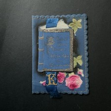 Unusual 1928 Blue Christmas Card Used book on front with picture under the flap