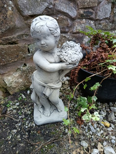 Stone garden cherub boy with