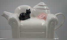 Black Cat Sitting On White