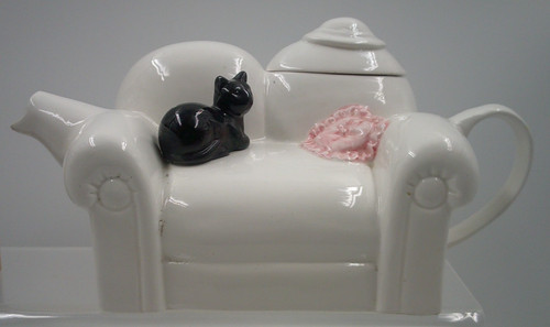 Black cat sitting white - sitting,