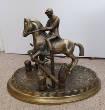 Vintage heavy brass figure of a horse rider jumping over a fence