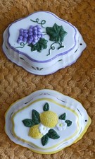 2 decorative vintage hanging jelly moulds.  Fruit design. 6" long. Slight wear.