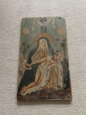 Antique painting of the madonna holding christ painted on wood