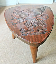 CARVED TOP SIDE TABLE WITH HERALDIC DESIGNED TOP.  SOLID SHAPED 3 SCREW IN LEGS