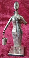 VINTAGE, UNUSUAL AFRICAN ART,  METAL LADY HOLDING TWO BUCKETS, (ONE ON HER BACK)