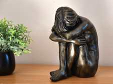 Small Girl sitting garden ornament finished in an aged bronze