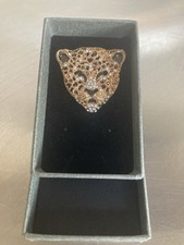 A Gold and Metal Tiger Head Shaped Brooch with Rhinestones