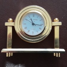 Miniature Brass W Widdup Quartz Mantle Clock - round mounted on 2 pillars
