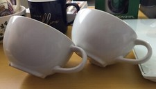 Two White Porcelain Coffee Cups.