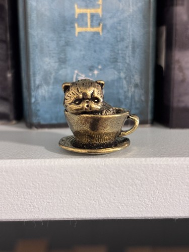 Small brass cat - in, teacup