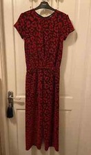 Next girls jumpsuit age 13 years with red glittery pattern and cross over back