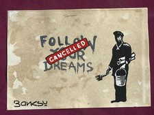 Banksy painting and drawing on