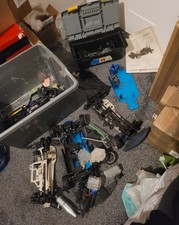 Rc chassis joblot with one nitro engine fuel tanks and other parts bargain