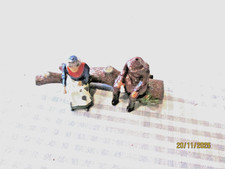 BRITAINS LEAD-FIGURES SITTING ON A LOG-UNBOXED