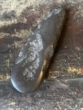 A Native American polished stone adze or celt woodworking tool.