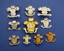 Ten various metal Prince-of Wales feathers badges