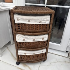 brown wicker 3-drawer storage unit with removable white cloth basket liners