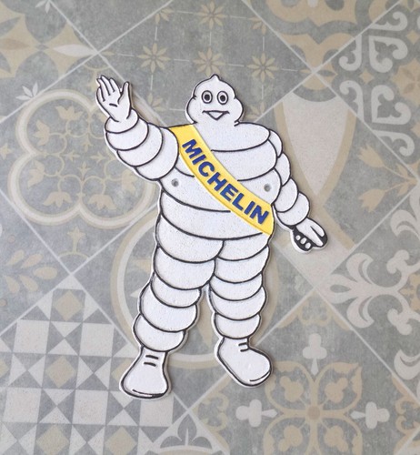 Michelin man waving cast iron - michelin,