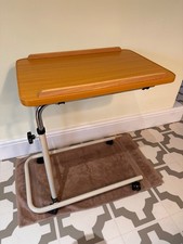 Overbed table, adjustable height and tilt.