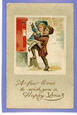 OLD VINTAGE CHRISTMAS POSTCARD YOUNG BOY LIFTING GIRL TO PUT LETTER IN POSTBOX