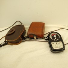 A small collection of vintage photographic light meters including Weston 