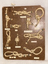 HARDBOARD BOARD WITH 10 BOY SCOUT ROPE KNOTS ON IT