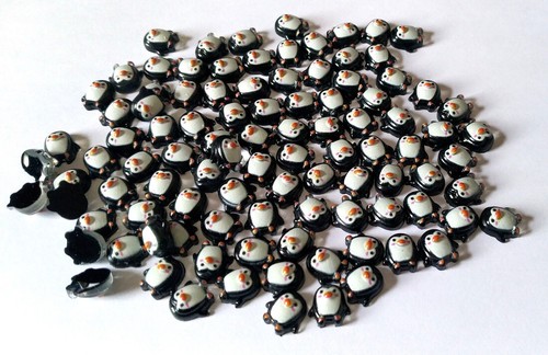 100 small black resin penguins - 100,