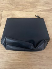 Ladies small black clutch bag/make up bag. No label. Good condition.
